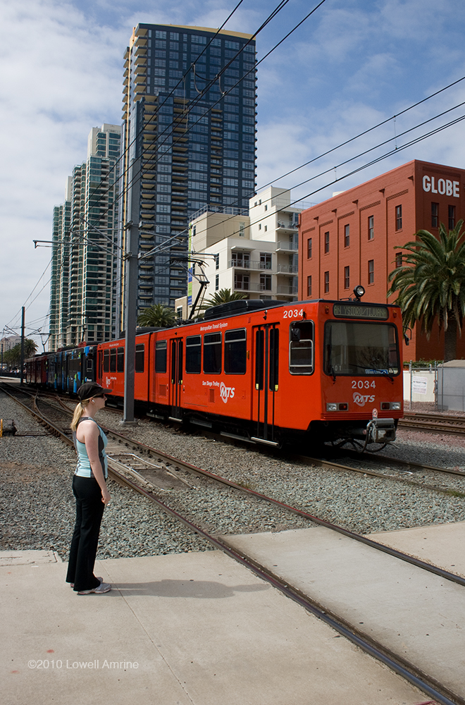 Girl waits for light rail vehicle to pass, San Diego,CA