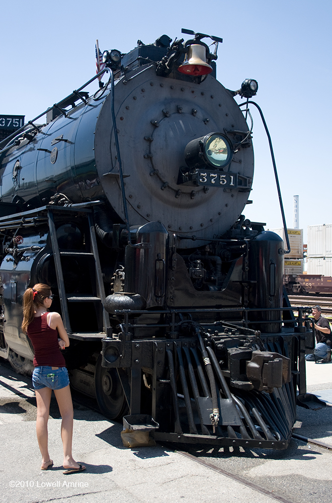 Teenage female admiring Santa Fe steam engine, San Bernardino, CA